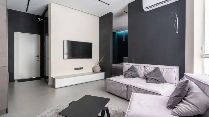 Unité intérieure de climatisation murale installée dans le salon d’un appartement