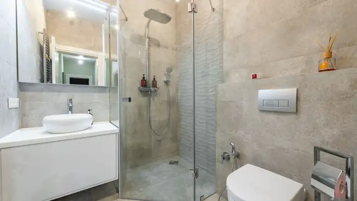 Salle de bain rénovée avec douche à l’italienne et paroi vitrée